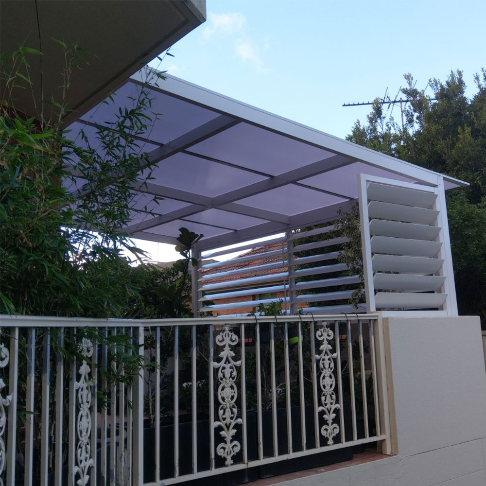 160mm adjustable horizontal aluminium louvres on the end of a patio cover, viewed from the outside with the blades open.