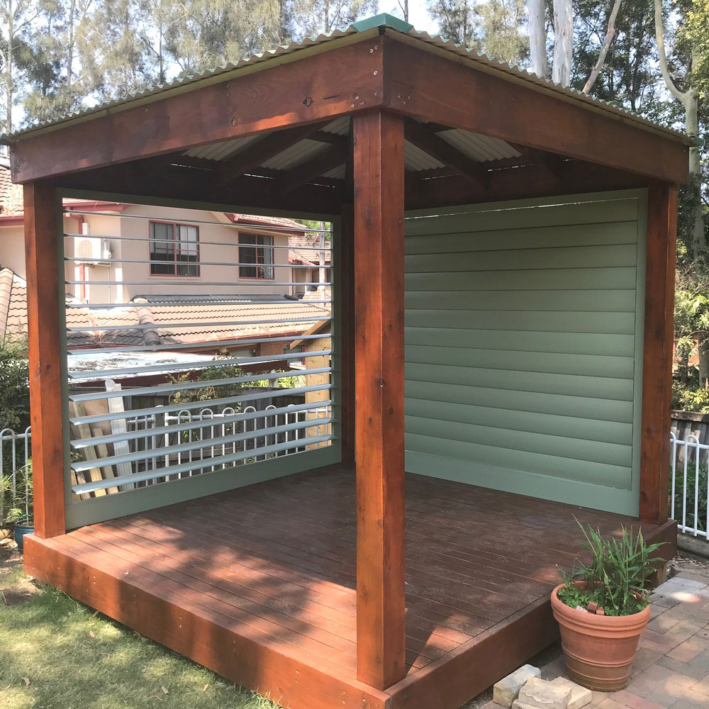 Horizontal aluminium louvres installed in a timber gazebo structure for shade, airflow and privacy.
