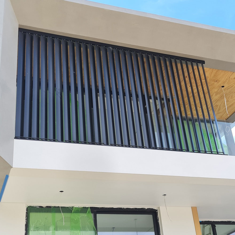 Vertical 160mm aluminium louvres built on site for a second-floor verandah, providing privacy, sun control and a modern architectural finish.