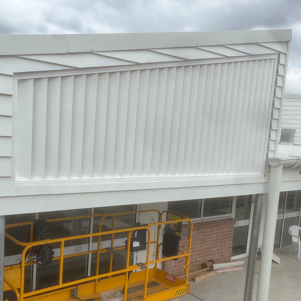 Angled 160mm fixed aluminium louvres fitted to follow the gable line, enclosing an internal patio.