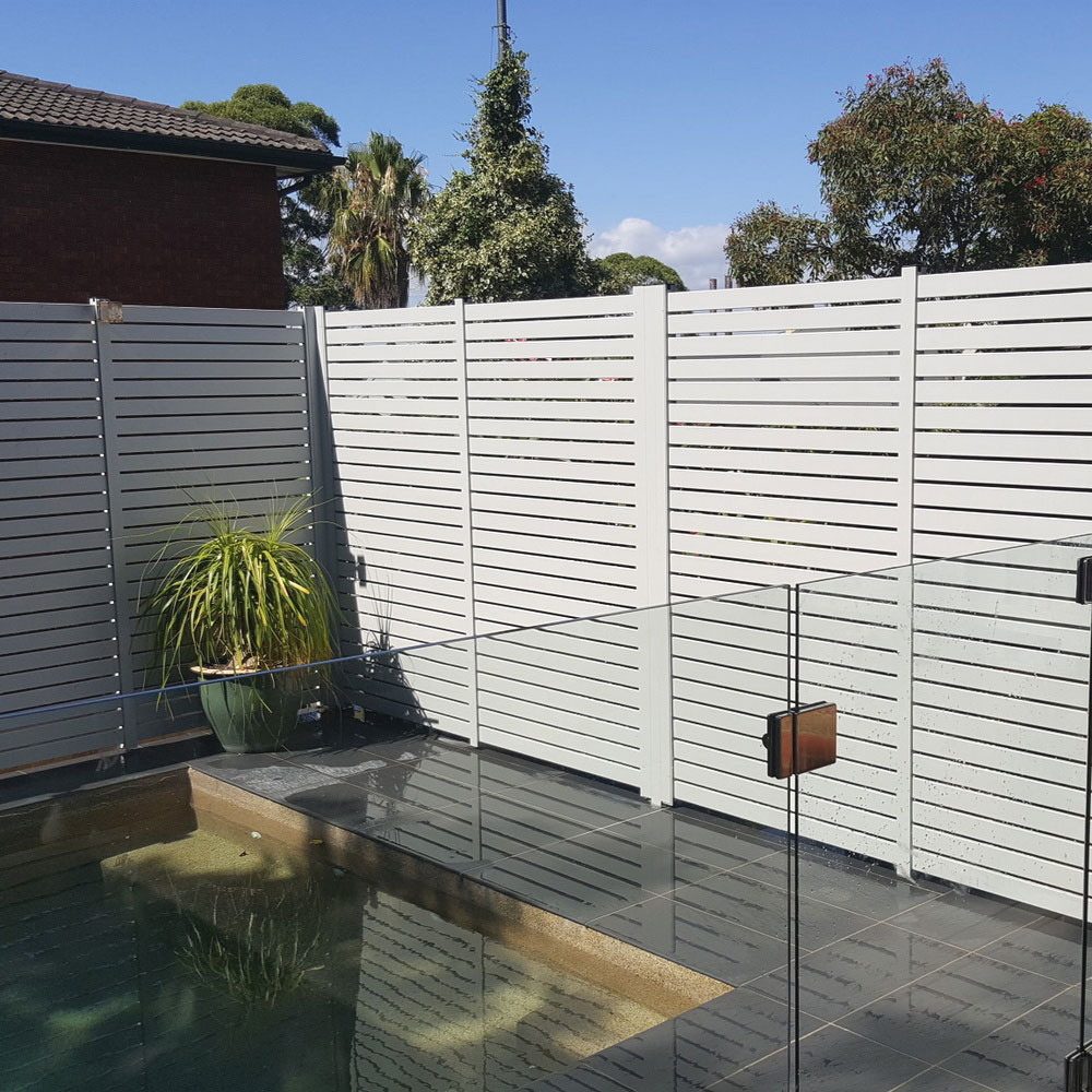 Aluminium slat fence installed around the perimeter of a pool, providing privacy and a clean modern finish.
