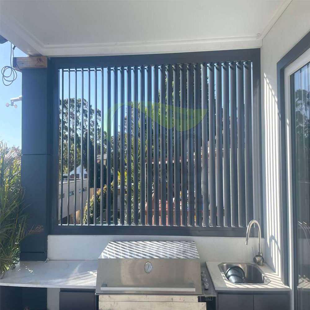 Vertical 85mm adjustable louvres behind a barbecue area shown from an angle with blades partially opened for airflow and light control.