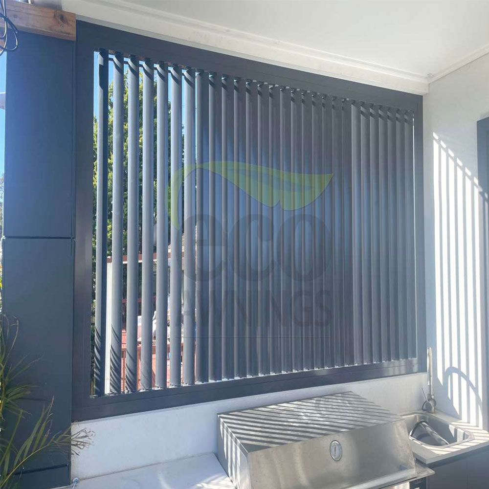 Vertical 85mm adjustable louvres installed behind an outdoor barbecue for shade, airflow and privacy.