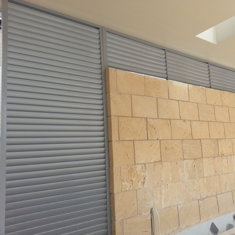 85mm fixed privacy louvres installed around the perimeter of a besser block wall.