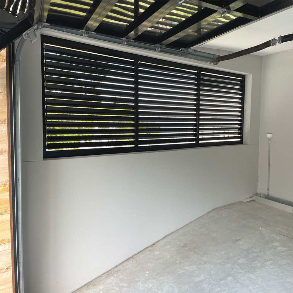 Adjustable 85mm aluminium louvre installed in a carport for ventilation and privacy.
