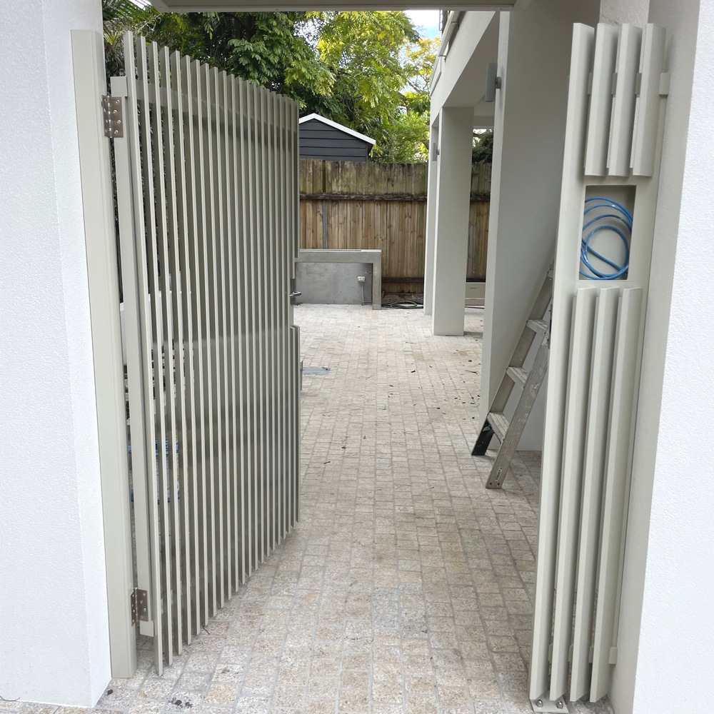 Vertical angled aluminium slat gate installed in a residential unit entry