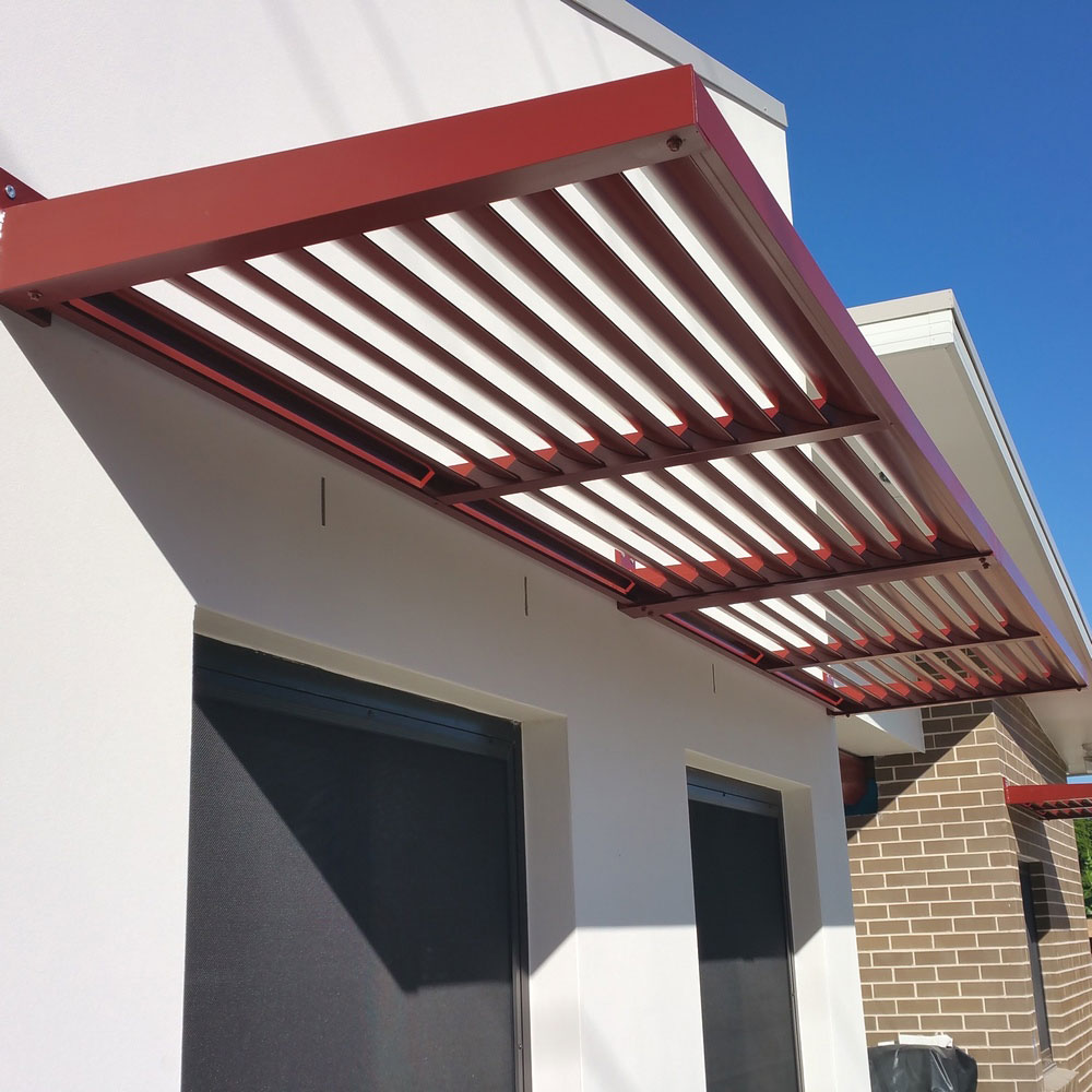 cantilever aluminium louvre awning mounted above exterior windows on a modern home.