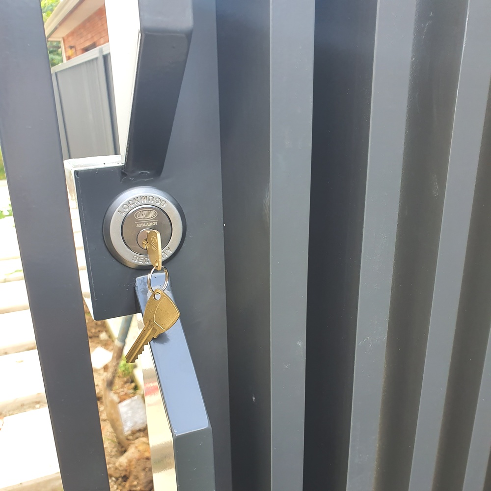Key lock fitted to custom aluminium gate with vertical slats