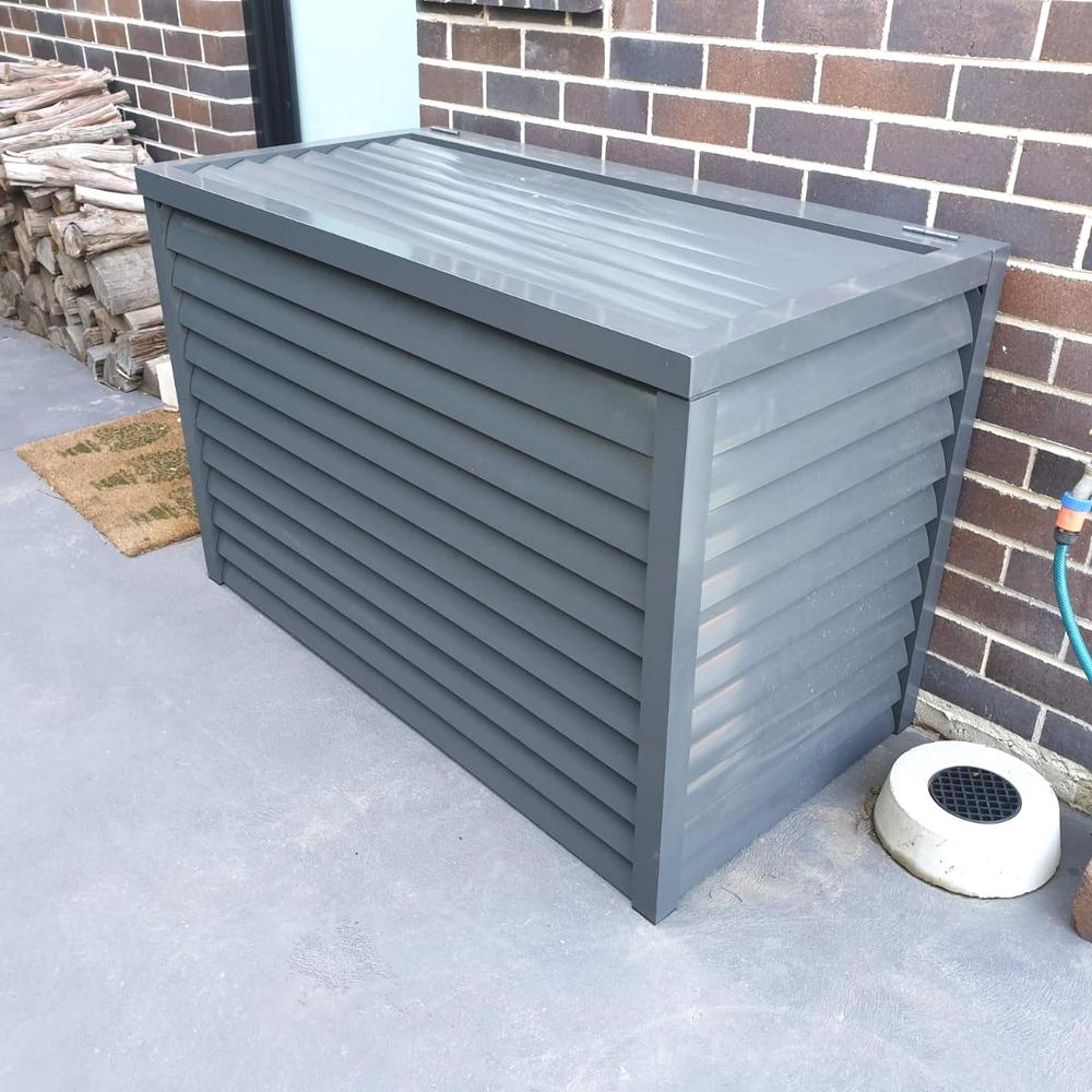 Powder-coated aluminium pool pump enclosure with fixed welded 85mm horizontal louvre blades installed against a brick wall.