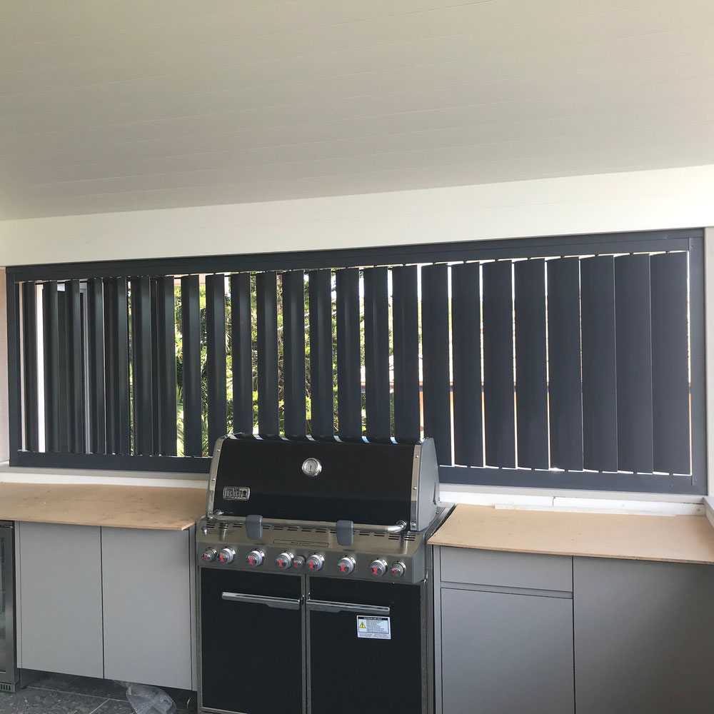 vertical adjustable louvres behind a barbecue