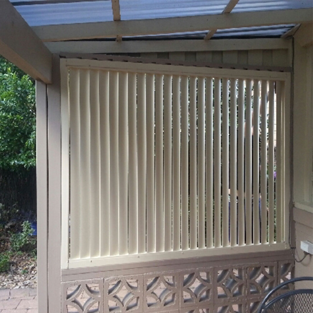Vertical 85mm aluminium louvres installed on the side of a veranda for added privacy and shade control.